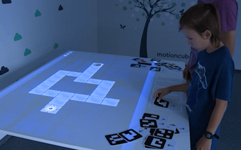 Interactive Card Table - augmented reality coding with printed cards on a projected game board